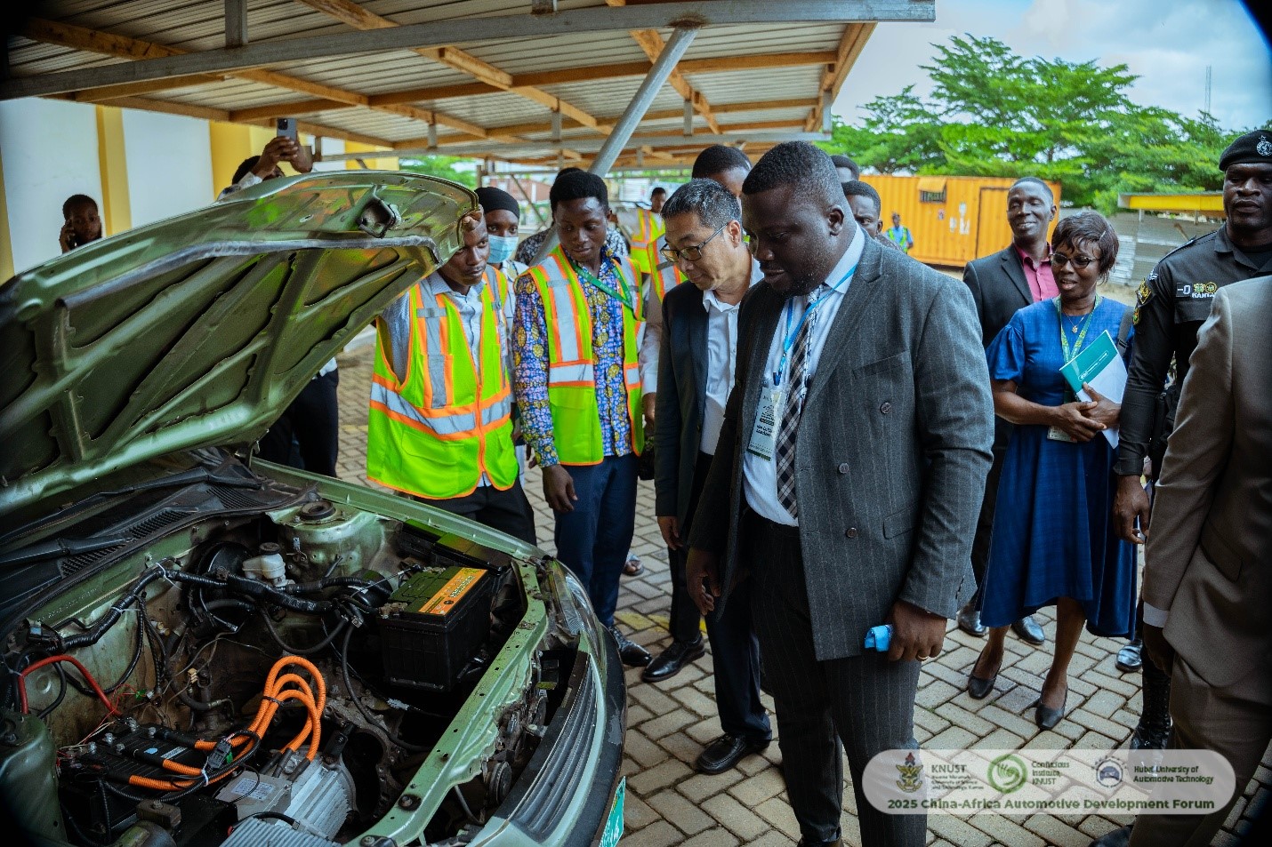 Key officials exploring electric vehicle innovations at the exhibition
