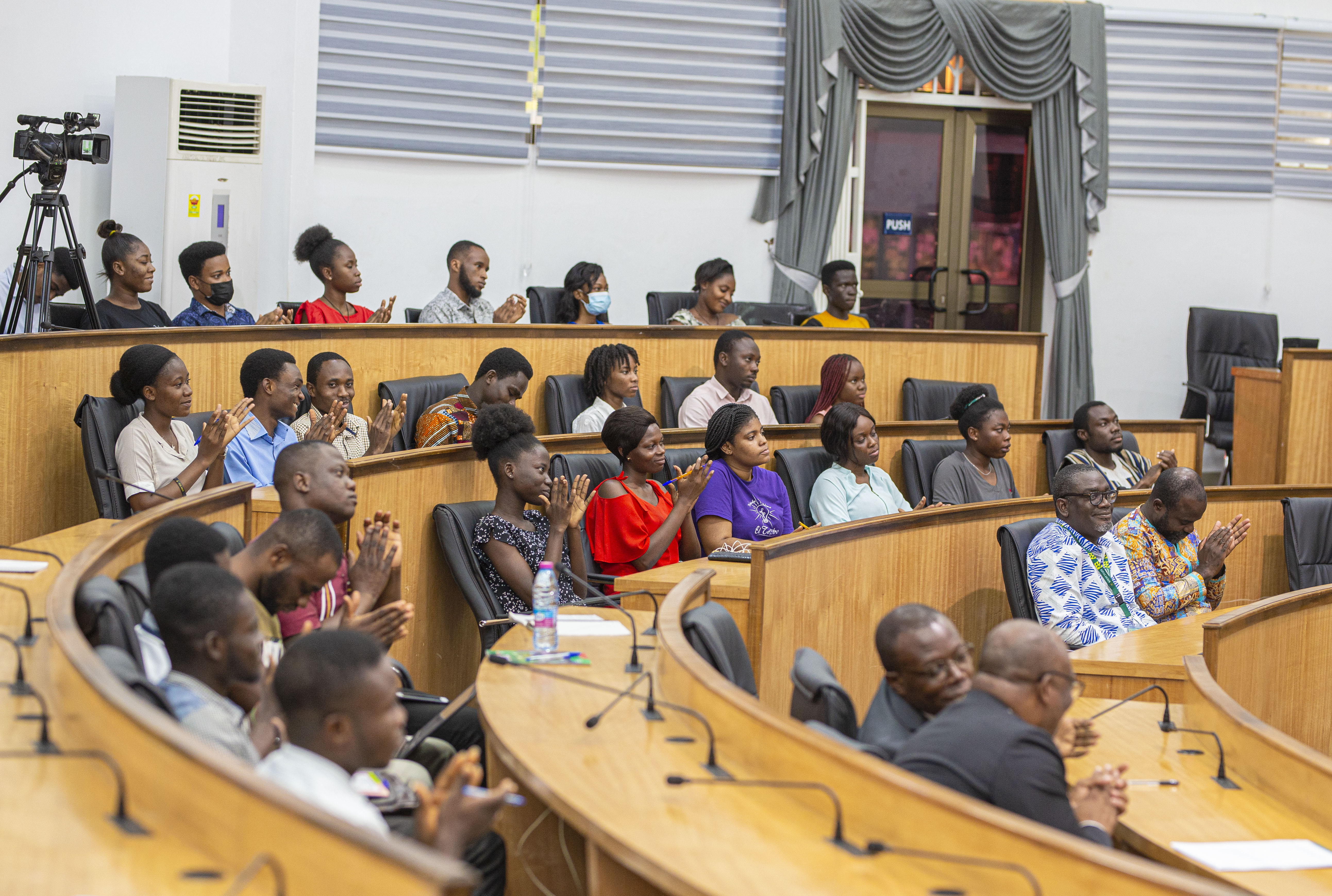 Participants applaud a speaker  