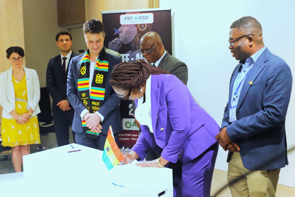 Mavis Ama Frimpong, Ambassador of Ghana to France, signs her part of the MoU