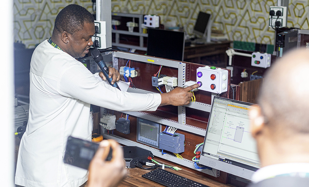 Ing. John Kusi, Principal Technician, Demonstrating an Operation of the Laboratory