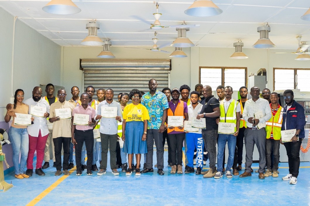 Participants holding their certificates alongside facilitators at the close of the SAFEFAG training