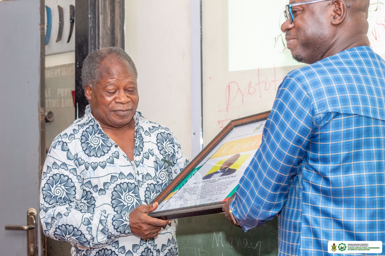 Dr. Joseph Ofei Darko (left) presenting a citation to Mr. Emmanuel Agyapong (right)